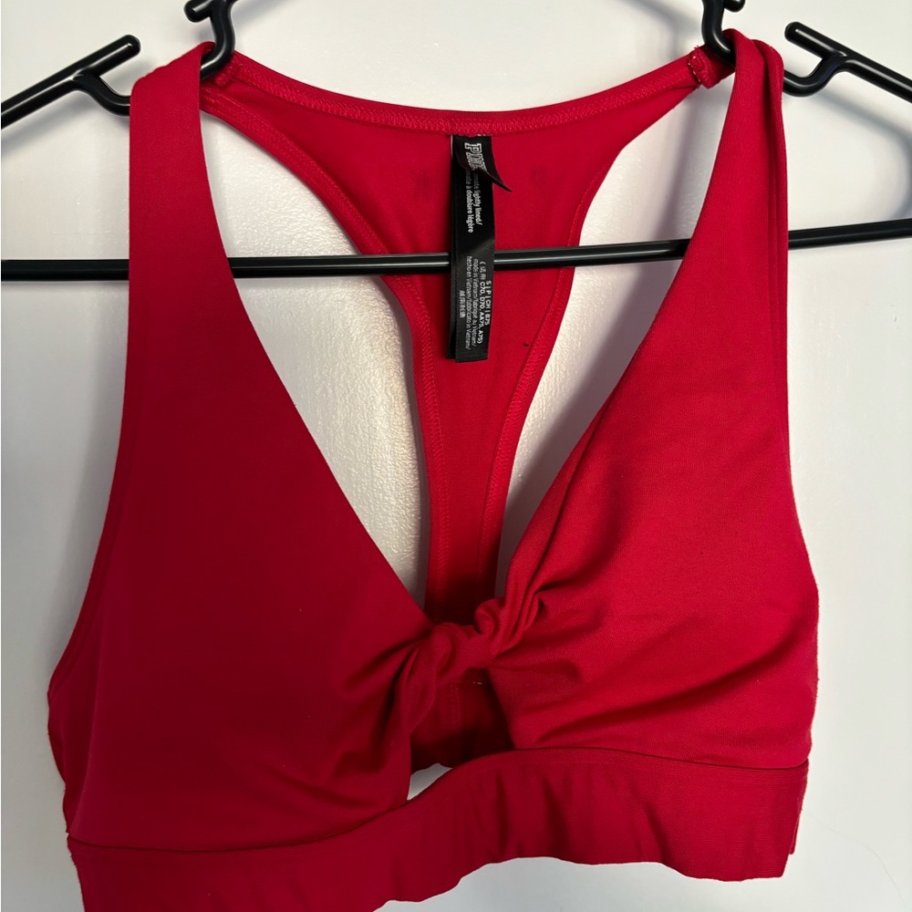 Red colored PINK sports bra